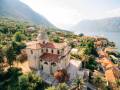 Church of the Nativity of the Virgin in Prcanj against the background of mountains